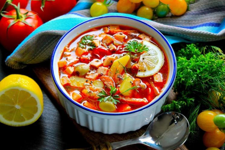 Hearty Solyanka Soup with Olives, Sausage, Lemon, and Cucumbers